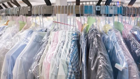 Clothes hanging on dry cleaning rack