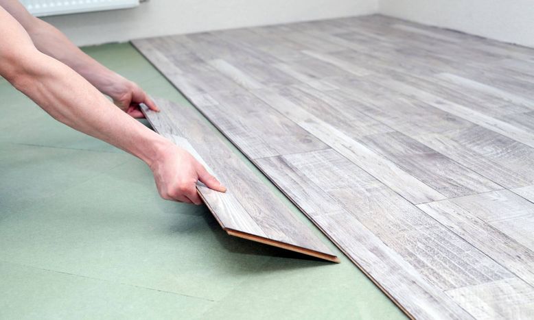 person installing laminate floor