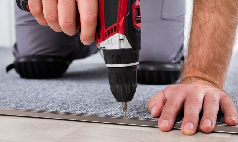 person installing carpet