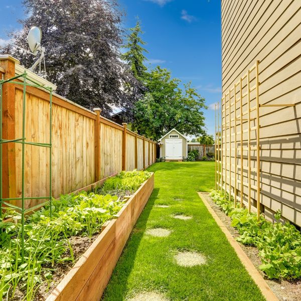 image of a fence next to a garden