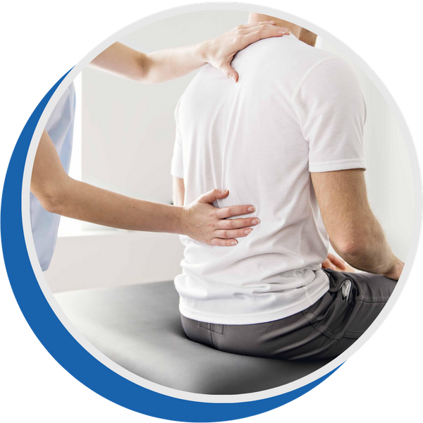 physical therapist examining and treating a patient's lower back on an examination table
