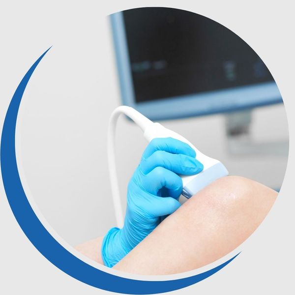 A doctor performing imaging on a knee