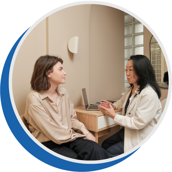 doctor sits with patient in an exam room