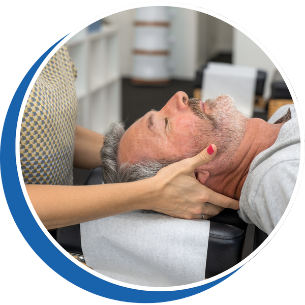 older man lying back with a provider clutching his neck