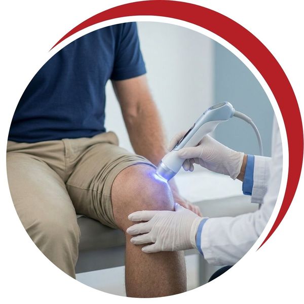 A focused close-up of a non-surgical knee treatment in progress