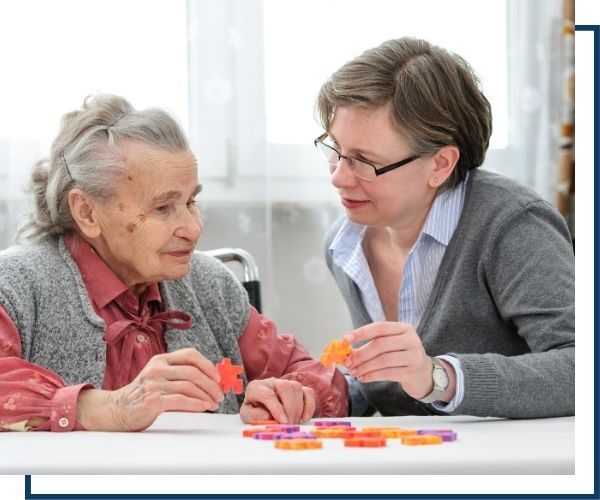 a woman and an elder woman doing a puzzle together