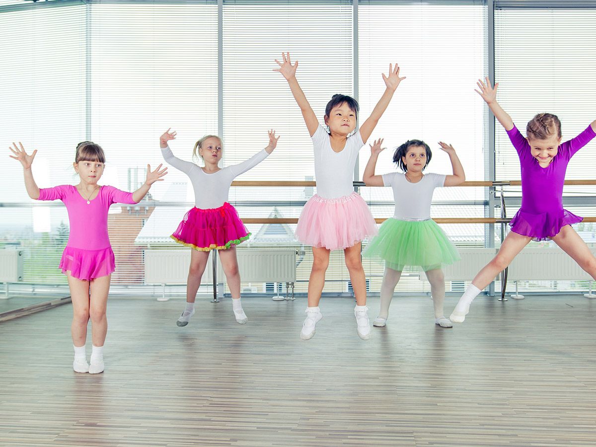 Happy children dancing on in hall