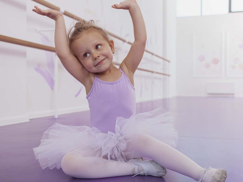 Child stretching before dance class