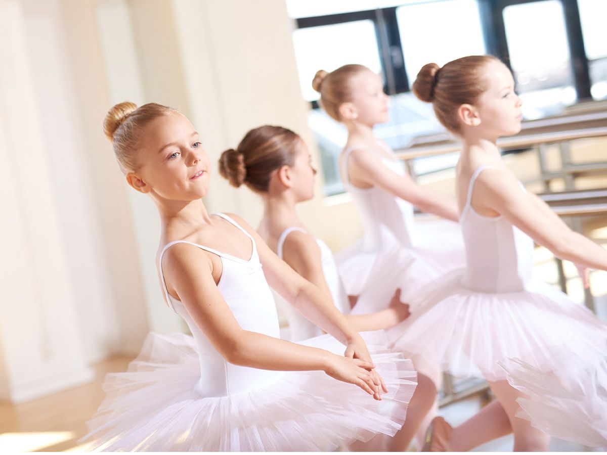 Cute Little Ballerinas Wearing White Tutus, Practicing their Dance Inside the Studio During their Ballet Class.
