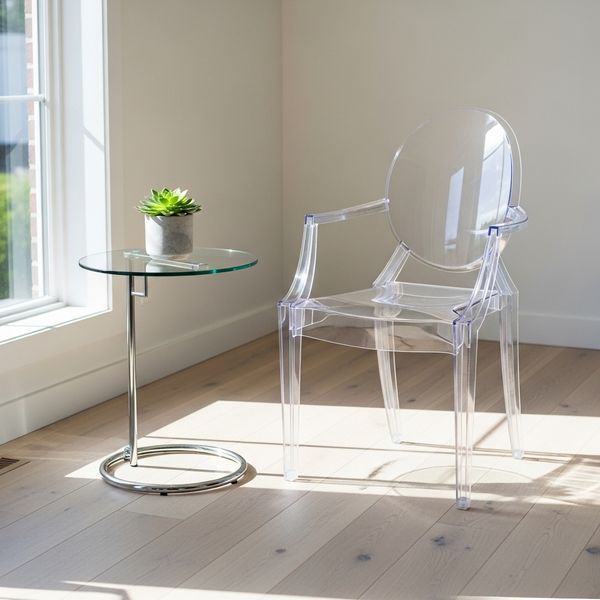 a clear acrylic "ghost" chair and a small glass side table