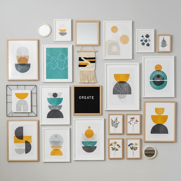 Assortment of framed art prints and DIY pieces creating a modern gallery wall.