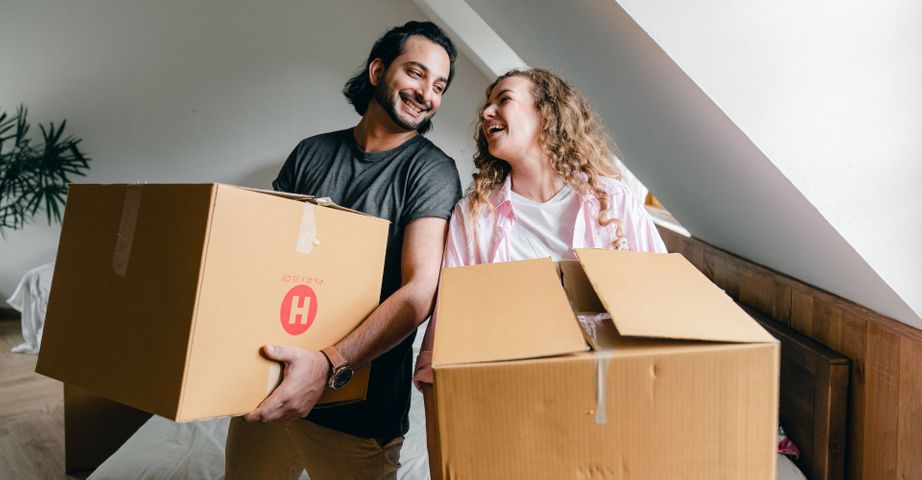 man and woman carrying boxes