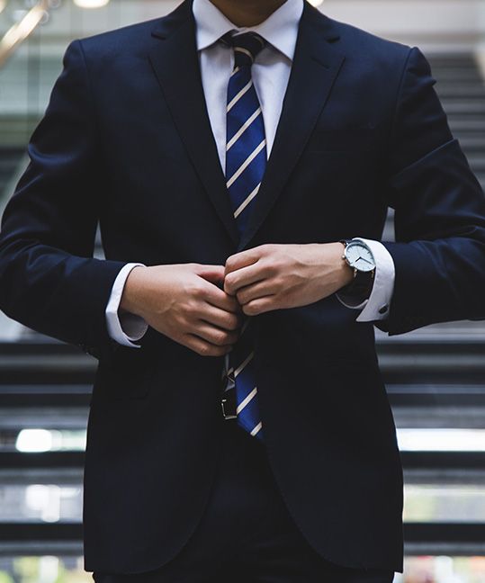 A lawyer buttoning up his suit jacket