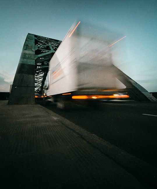 A truck driving onto a bridge