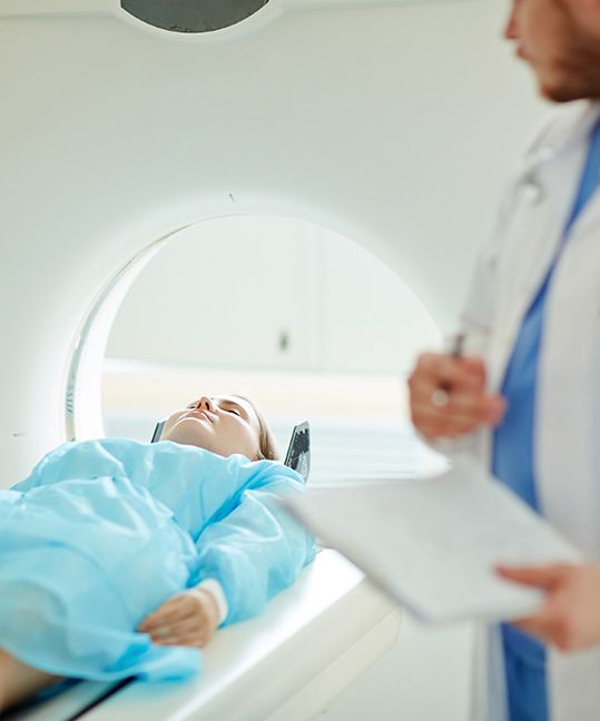 A young woman getting a CT scan
