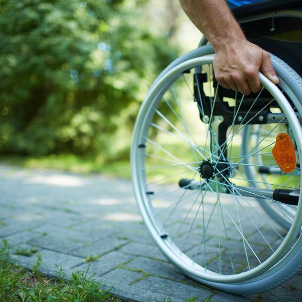closeup of a wheelchair and hand on wheel