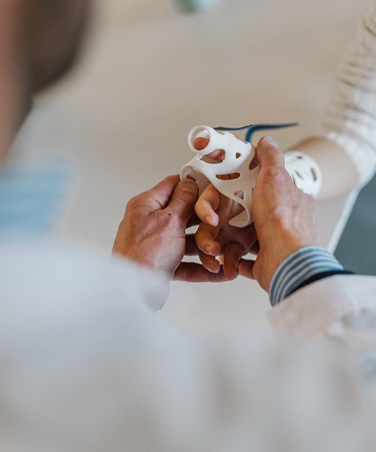 A doctor putting a brace on a patient's hand