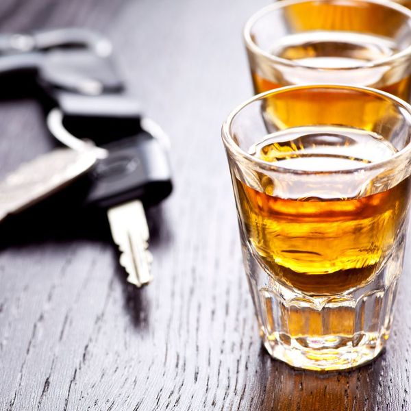 two shots of alcohol sitting next to a pair of car keys