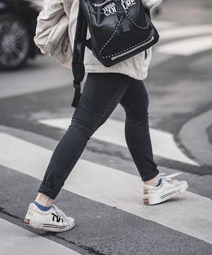 A woman crossing the street in a crosswalk