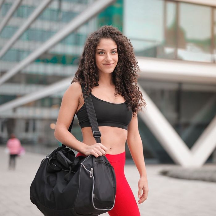 Person with curly hair in Gym clothes