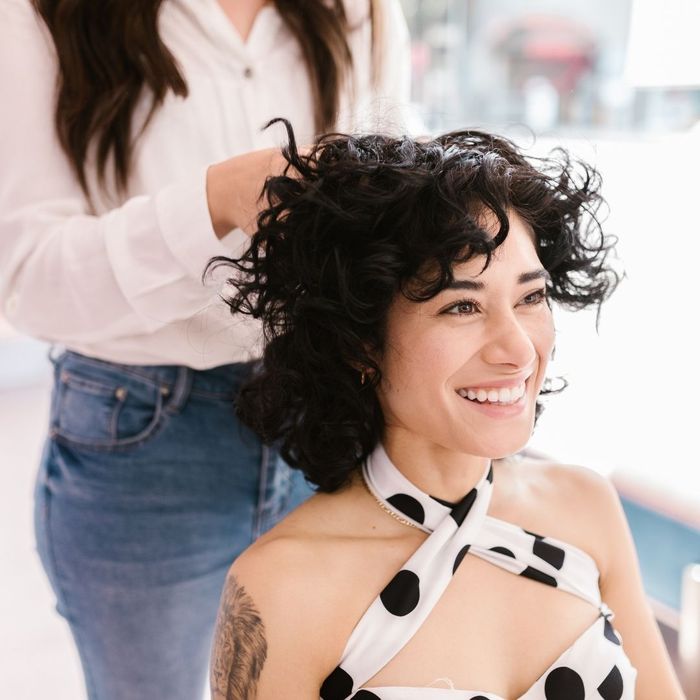 person touching another person's hair