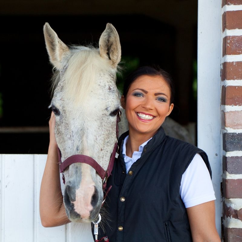 woman smiling with horse