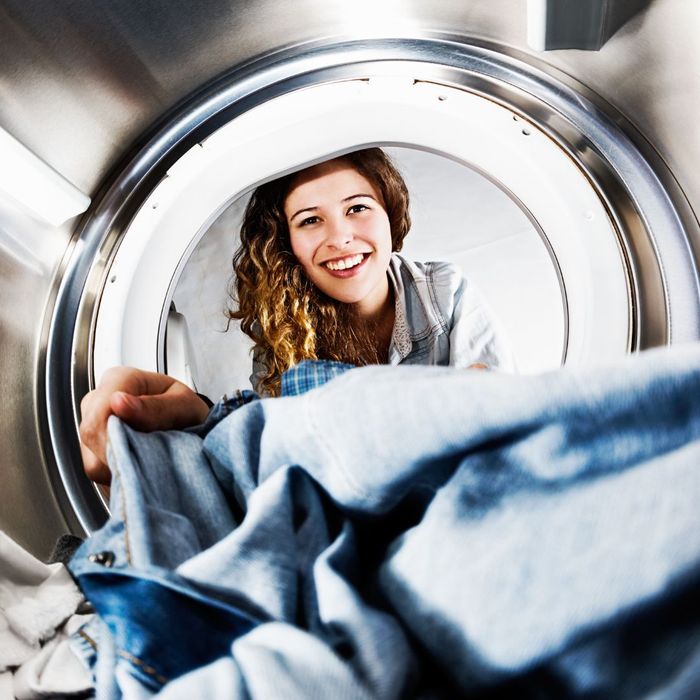 woman pulling laundry out of dryer