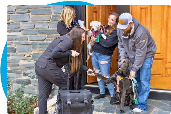 the Wagging Wheels Veterinary greeting clients at their door