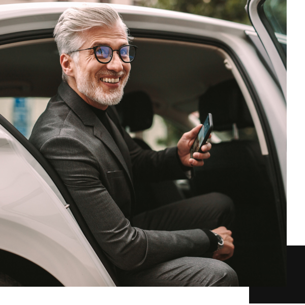 man in a suit getting out of a car