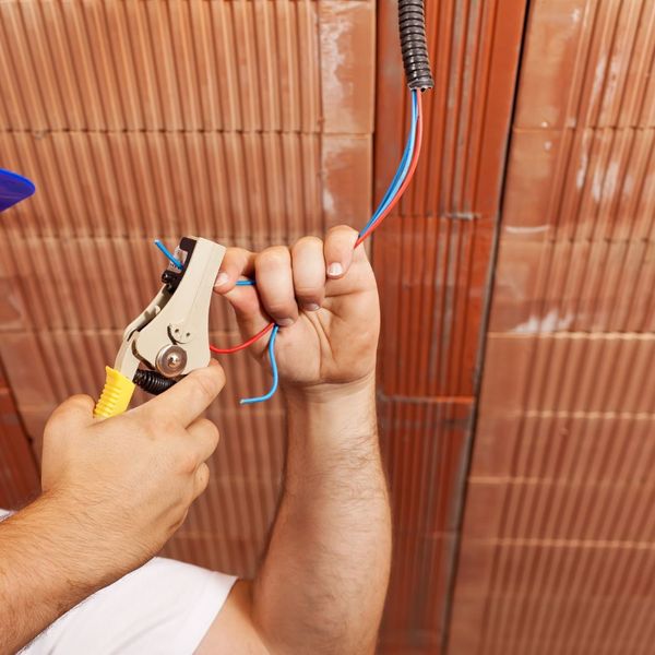 An electrician repairing a wire