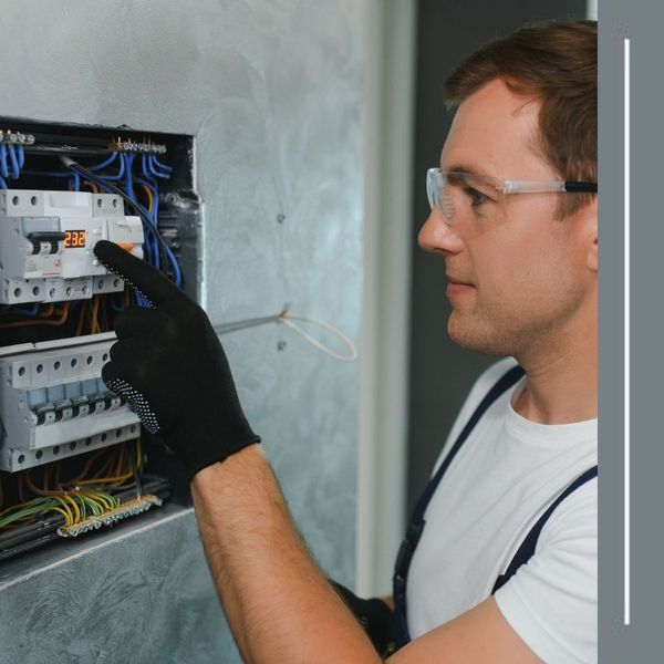 electrician working on electrical panel