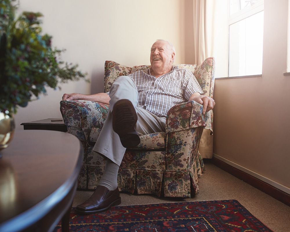 happy elderly man sitting on chair