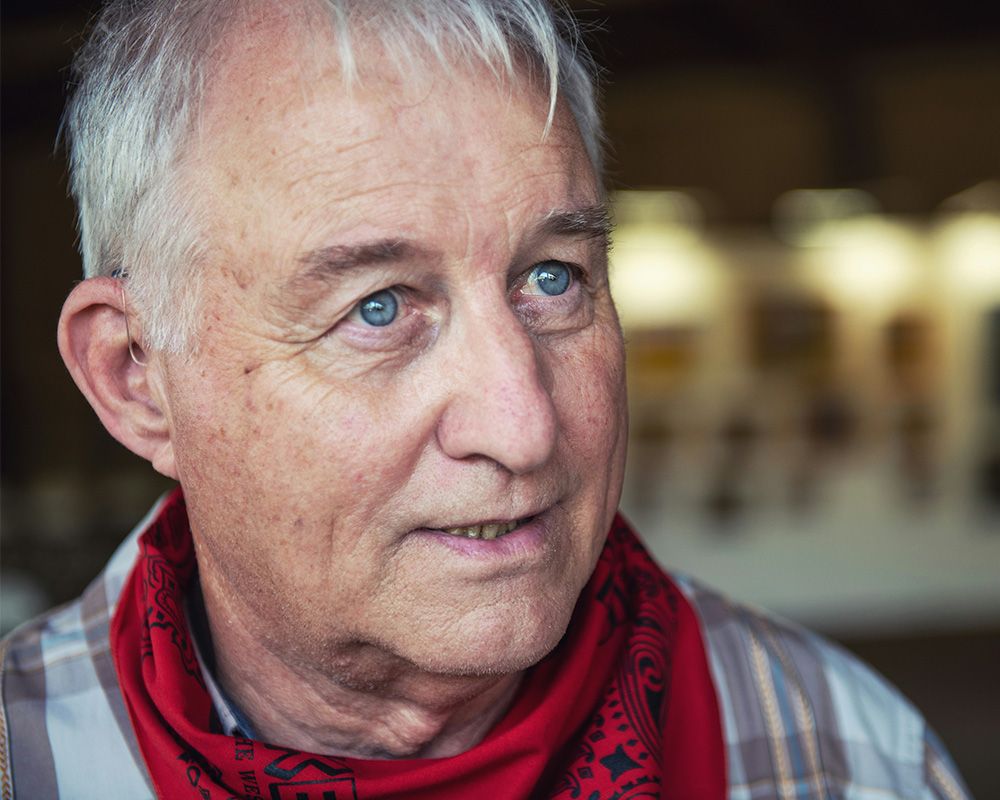 older man in bandana talking to person off-camera