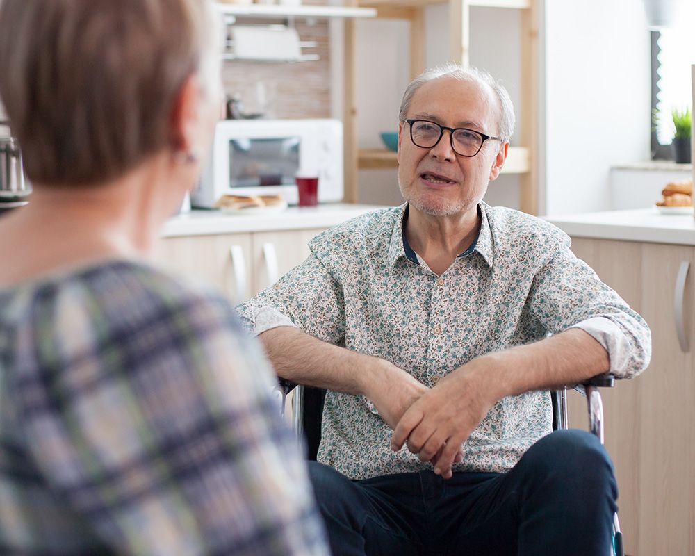 conversation with elderly man in chair