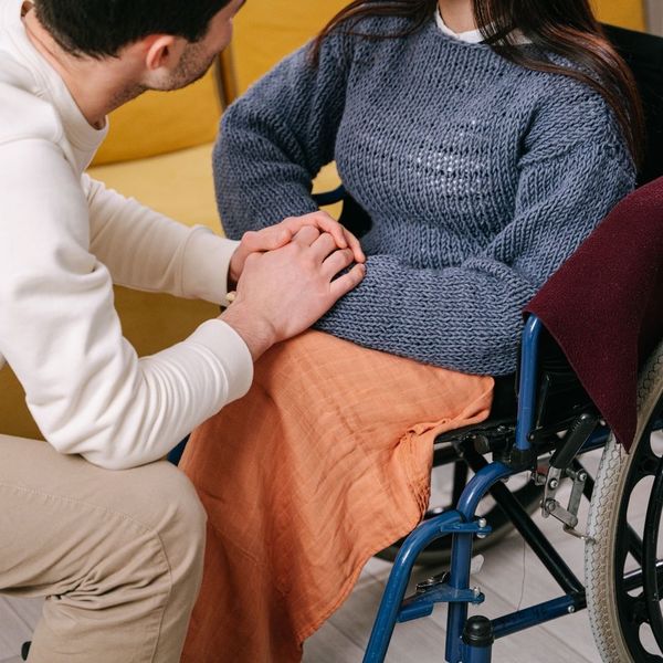  Two pairs of hands gently clasped together, symbolizing care and support.
