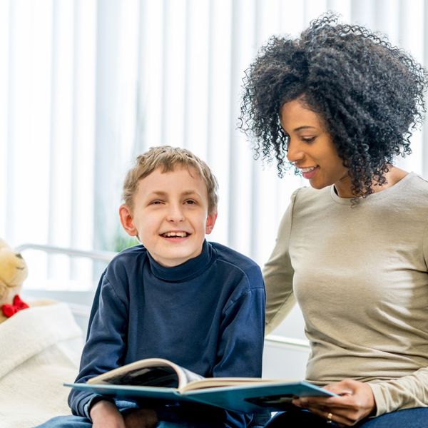 caregiver reading book with young patient