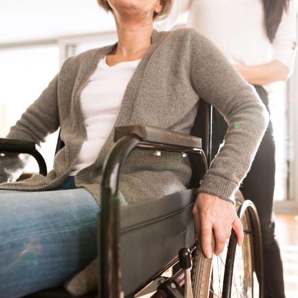 caregiver assisting woman in wheelchair