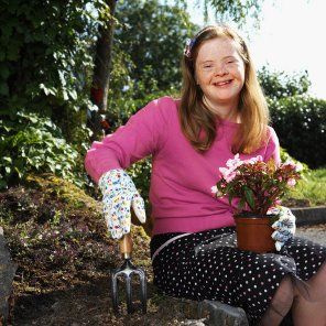 Girl with Down Syndrome working in a garden