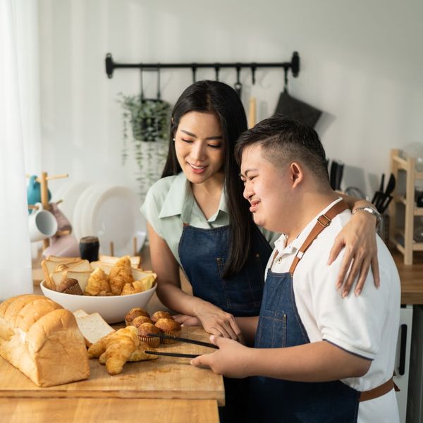 woman cooking with man with special needs