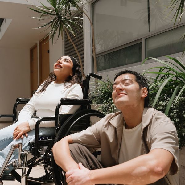 two people sitting outside enjoying the sun