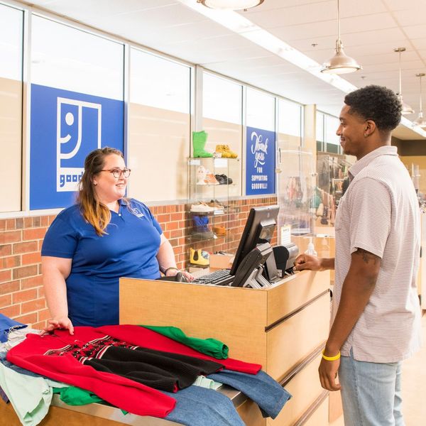 Customer purchasing clothes at Goodwill checkout