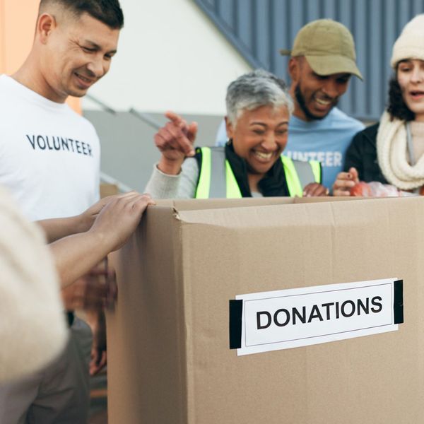 Donations box and laughing volunteers