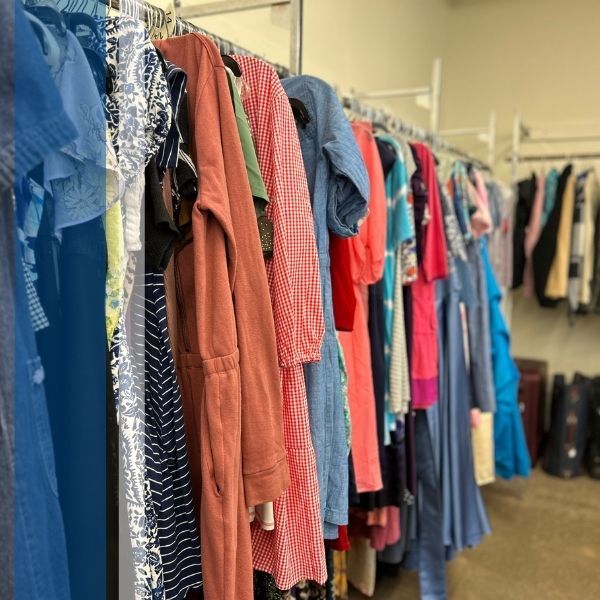 A rack of dresses in a Goodwill store