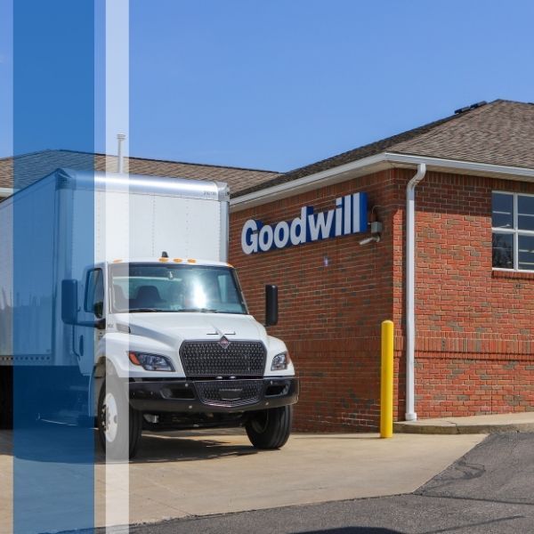 The loading area of the Wooster Goodwill store, with a truck and the building's logo visible