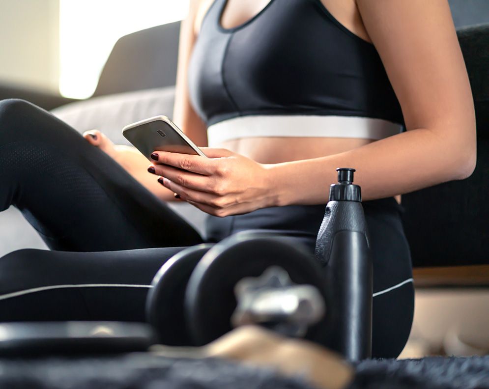 Image of a girl with workout gear and a phone