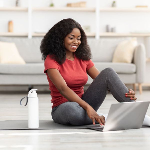 woman sitting on floor by laptop