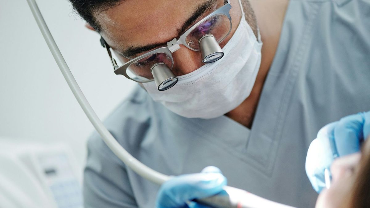 A dentist examining patient's teeth