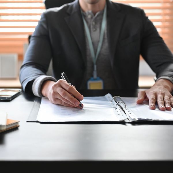 private investigator taking notes during a consultation