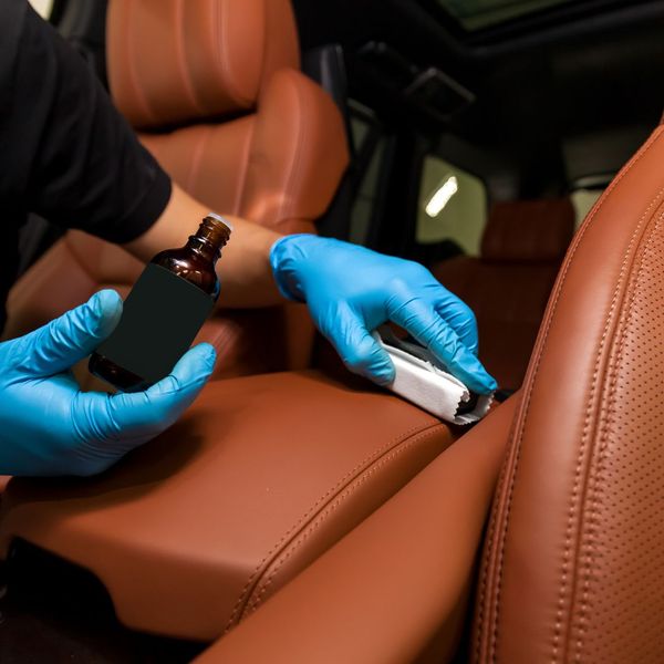 someone applying oil to leather