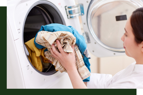 woman putting clothes in washer